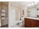 Neat bathroom offers tub, shower, white fixtures, and practical storage shelves at 22560 E Rowland Dr, Aurora, CO 80016