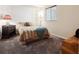Inviting bedroom featuring a comfortable bed, dark dresser, and soft lighting at 22560 E Rowland Dr, Aurora, CO 80016