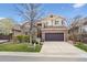 Charming two-story home boasts a brick facade, well-maintained lawn, and attached two-car garage at 22560 E Rowland Dr, Aurora, CO 80016