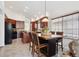 Well-equipped kitchen with stainless steel appliances, wooden cabinets, and a cozy dining area at 22560 E Rowland Dr, Aurora, CO 80016