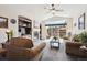 Cozy living room with fireplace, built-in shelving, and sliding glass doors to the outdoor patio at 22560 E Rowland Dr, Aurora, CO 80016