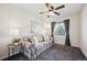 Comfortable living room with a floral sofa, ceiling fan, and bright window at 22560 E Rowland Dr, Aurora, CO 80016