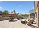 Outdoor patio featuring stylish outdoor seating, gas fire pit, and manicured garden beds at 22560 E Rowland Dr, Aurora, CO 80016
