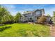 Back yard with patio furniture and mature trees at 860 Quintana Ln, Erie, CO 80516