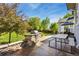 Backyard with built-in stone grill, patio area, and manicured lawn at 860 Quintana Ln, Erie, CO 80516