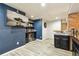 Finished basement bar with custom shelving, entertainment area and mini fridge at 860 Quintana Ln, Erie, CO 80516