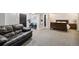 Basement living area and bedroom with carpet floors and dark trim at 860 Quintana Ln, Erie, CO 80516