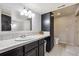 Bathroom with a vanity, large mirror, and tile countertops at 860 Quintana Ln, Erie, CO 80516