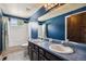 This bathroom offers a dual sink vanity with a large mirror and a shower and tub combo at 860 Quintana Ln, Erie, CO 80516