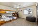 Cozy bedroom with a bunk bed, chair, and natural light, creating a comfortable and functional space at 860 Quintana Ln, Erie, CO 80516