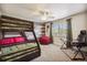 This bright bedroom offers fun bunk beds, natural light, and an accent wall for added decor at 860 Quintana Ln, Erie, CO 80516