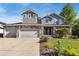 Charming two-story home featuring stone accents, an attached three-car garage, and a well-manicured front yard at 860 Quintana Ln, Erie, CO 80516