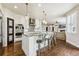 Modern kitchen with a large island, stainless steel appliances, and elegant pendant lighting at 860 Quintana Ln, Erie, CO 80516