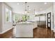 Bright kitchen with granite countertops, stainless steel refrigerator, and stylish fixtures at 860 Quintana Ln, Erie, CO 80516