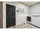Laundry room with new machines, modern flooring, and custom shelving at 860 Quintana Ln, Erie, CO 80516