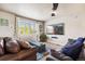 Comfortable living area with plush seating, natural light, and modern entertainment setup for relaxation at 860 Quintana Ln, Erie, CO 80516
