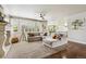 Spacious living room featuring large windows, a comfortable sectional sofa, fireplace, and a seamless open layout at 860 Quintana Ln, Erie, CO 80516