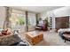Bright living room featuring large windows, hardwood floors, piano, neutral colors, and stylish furniture at 860 Quintana Ln, Erie, CO 80516