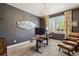 Well-lit home office space with neutral walls, comfortable seating, and a sleek workstation at 860 Quintana Ln, Erie, CO 80516