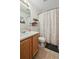 Bathroom featuring a vanity sink, toilet, and shower with a decorative shower curtain at 10223 Vine Ct, Thornton, CO 80229