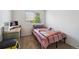 Bright bedroom with large window, carpeted floors, and computer table; the perfect work-study space at 10223 Vine Ct, Thornton, CO 80229