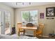This bedroom has a cozy desk area with a window view and hockey decor at 10223 Vine Ct, Thornton, CO 80229