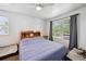 Bright bedroom with ceiling fan, carpet flooring, light walls and blue comforter, plus two pet beds at 10223 Vine Ct, Thornton, CO 80229