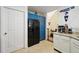 Kitchen featuring a black refrigerator and blue overhead cabinets at 10223 Vine Ct, Thornton, CO 80229