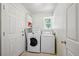 Bright laundry room with washer, dryer, storage, and window, offering convenience and functionality at 10223 Vine Ct, Thornton, CO 80229