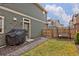 Cozy backyard featuring green lawn, porch swing, grill, and a wooden fence for added privacy at 203 S Oak Hill St, Aurora, CO 80018
