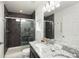Modern bathroom with a granite-topped vanity, sleek fixtures, and a beautifully tiled glass-enclosed shower at 203 S Oak Hill St, Aurora, CO 80018