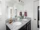 Modern bathroom featuring double sinks with granite countertops and dark cabinetry at 203 S Oak Hill St, Aurora, CO 80018