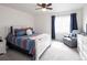 Bright bedroom featuring plush carpet, a ceiling fan, and a comfortable sitting area with natural light at 203 S Oak Hill St, Aurora, CO 80018