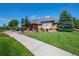 Community clubhouse with a well-manicured lawn, brick facade, and covered entrance at 203 S Oak Hill St, Aurora, CO 80018