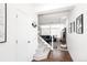 Bright entryway featuring hardwood floors, carpeted stairs, and ample natural light at 203 S Oak Hill St, Aurora, CO 80018
