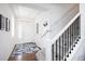 Bright entryway featuring hardwood floors, carpeted stairs, and ample natural light at 203 S Oak Hill St, Aurora, CO 80018