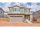 Charming two-story home with a stone-clad facade and an attached two-car garage at 203 S Oak Hill St, Aurora, CO 80018