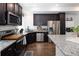 Modern kitchen featuring dark cabinets, stainless steel appliances, and granite countertops at 203 S Oak Hill St, Aurora, CO 80018