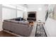 Cozy living room with a comfortable gray sofa, television, and patterned rug at 203 S Oak Hill St, Aurora, CO 80018