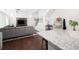 Comfortable living room featuring a gray sofa, television, and hardwood floors at 203 S Oak Hill St, Aurora, CO 80018