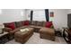 Spacious living room with a large, comfortable sectional sofa, complemented by an ottoman and tasteful decor at 203 S Oak Hill St, Aurora, CO 80018