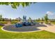 Community playground with play equipment and swings surrounded by well-maintained landscaping and community buildings at 203 S Oak Hill St, Aurora, CO 80018