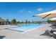Community pool with lounge chairs, umbrellas, and splash pad on a clear day at 203 S Oak Hill St, Aurora, CO 80018