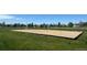 Community sand volleyball court with net and boundaries, set in a grassy area at 203 S Oak Hill St, Aurora, CO 80018