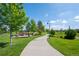 Well-maintained walking path winding through the community with mature trees and landscaping at 203 S Oak Hill St, Aurora, CO 80018