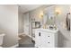 Stylish bathroom with a modern vanity, gold fixtures, and sleek tile flooring at 2999 S Adams St, Denver, CO 80210