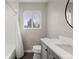 Bathroom featuring a bathtub with shower, subway tile, gray vanity, and window with outside view at 2999 S Adams St, Denver, CO 80210