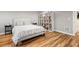 Finished basement bedroom featuring a bed, bookcase, and hardwood floors at 2999 S Adams St, Denver, CO 80210