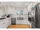 Well-lit kitchen with white cabinets, stainless steel appliances, and subway tile backsplash at 2999 S Adams St, Denver, CO 80210