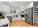 Contemporary kitchen with white cabinets, stainless steel appliances, and a farmhouse sink at 2999 S Adams St, Denver, CO 80210